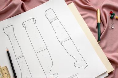 Image of a custom dress being drafted or worked on, highlighting the creative process.